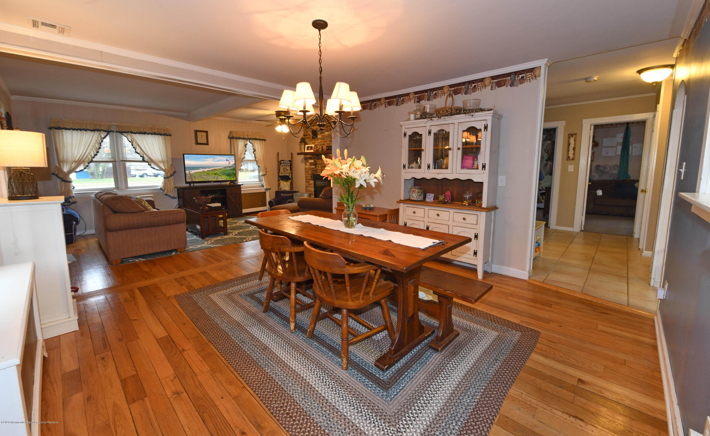 1871 Lanes Mill Road Brick, NJ 08724 - Photo 8 of 31 a view of a dining room with furniture a chandelier and wooden floor