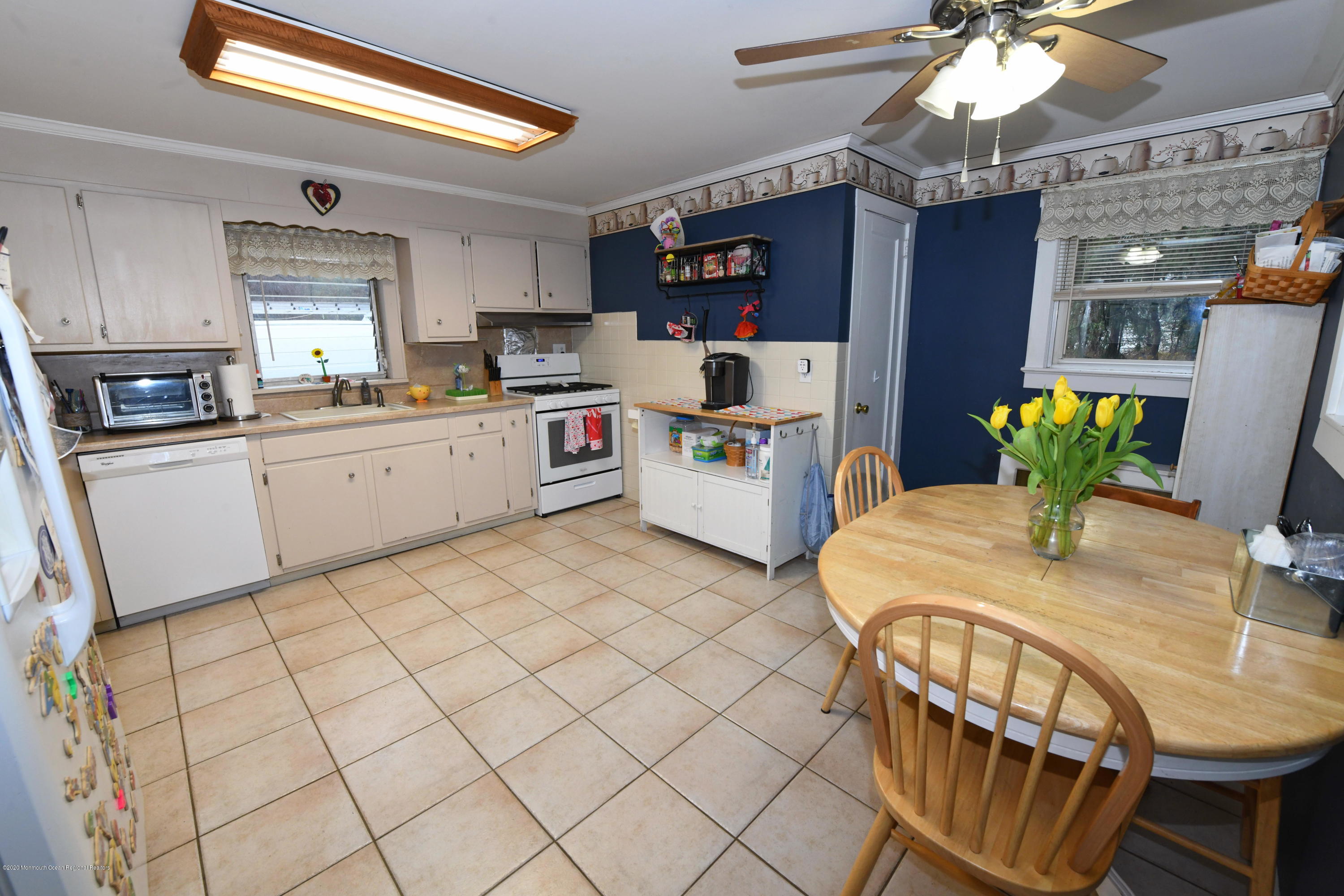 1871 Lanes Mill Road Brick, NJ 08724 - Photo 10 of 31 a kitchen with stainless steel appliances kitchen island granite countertop a refrigerator a stove top oven a dining table and chairs with wooden floor