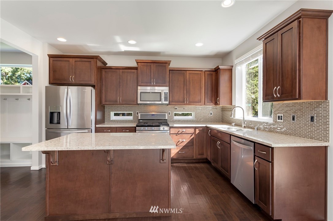 18504 115th Place Southeast Renton, WA 98055 - Photo 14 of 40 a large kitchen with a large window and stainless steel appliances