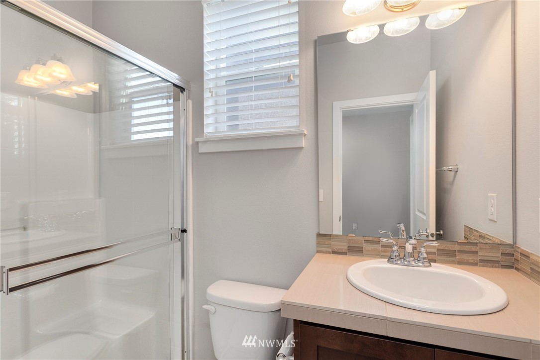 18504 115th Place Southeast Renton, WA 98055 - Photo 38 of 40 a bathroom with a sink a toilet and a mirror