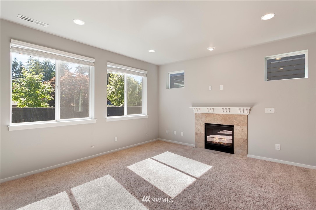 18504 115th Place Southeast Renton, WA 98055 - Photo 6 of 40 a view of an empty room with a window and a fireplace