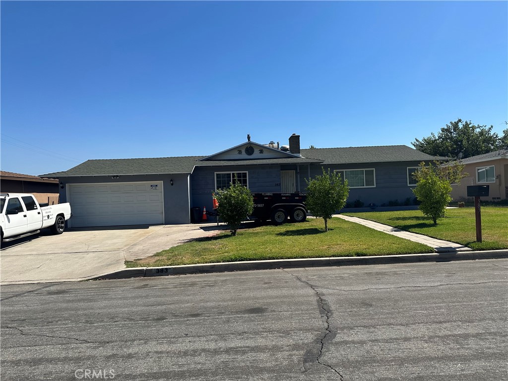 383 East Jackson Street Rialto, CA 92376 - Photo 1 of 1 a view of a house with a yard and potted plants