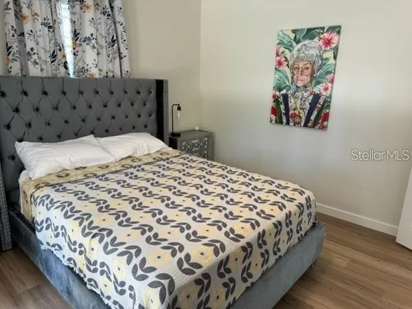 a large bed sitting in a bedroom next to a window