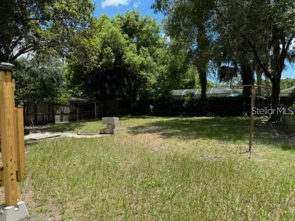 a swimming pool with outdoor seating and yard