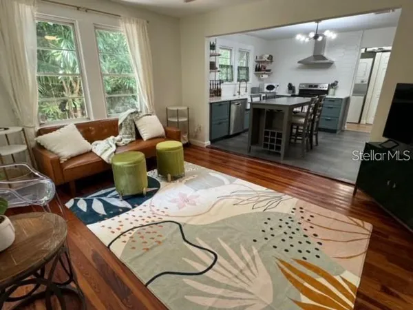 a living room with furniture a bed and a table