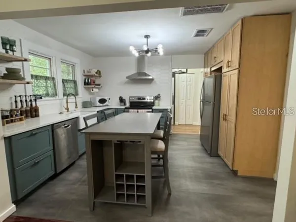 a kitchen with a table chairs refrigerator and microwave