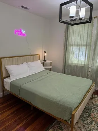 a bed sitting in a bedroom next to a window