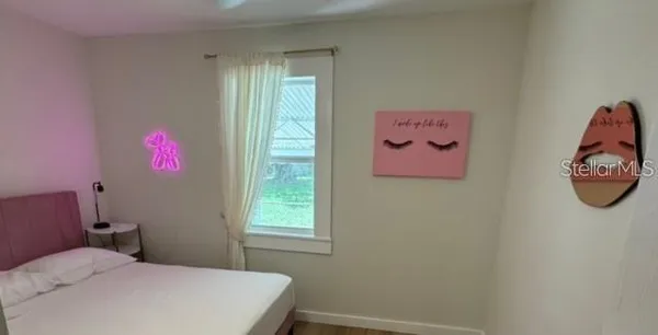 a bedroom with a bed and a window