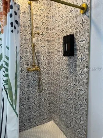 a bathroom with a toilet and a shower curtain