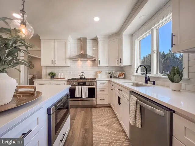 a kitchen with a sink stove and cabinets