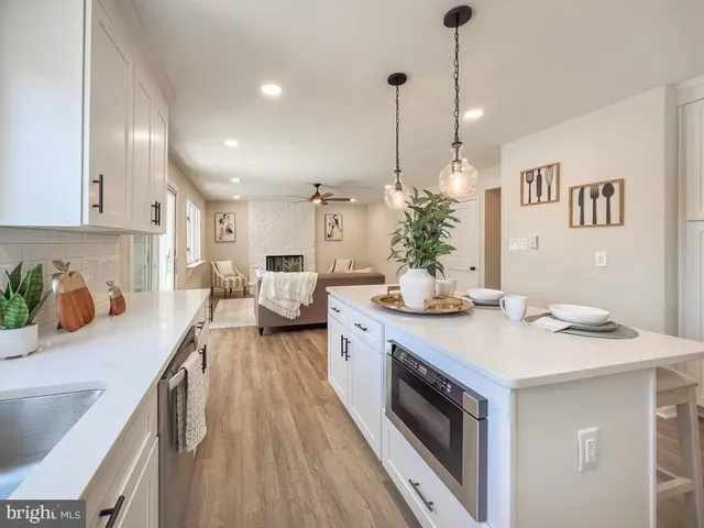 a kitchen with sink a stove and cabinets