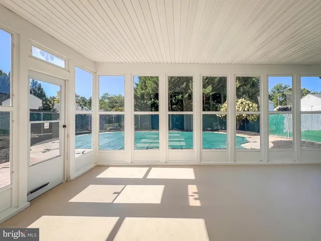 a view of a hall with wooden floor and windows
