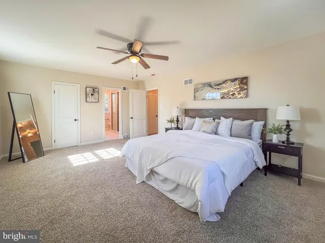 a spacious bedroom with a bed and a walk in closet
