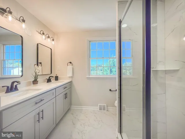 a bathroom with a double vanity sink mirror and double