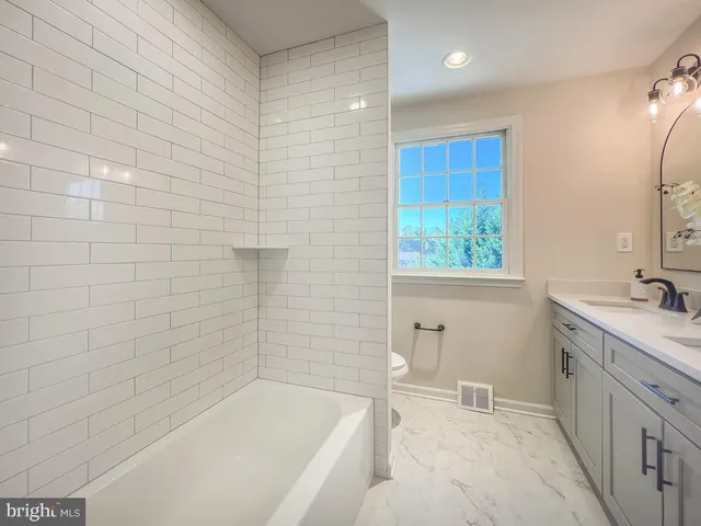 a bathroom with a bathtub and a sink
