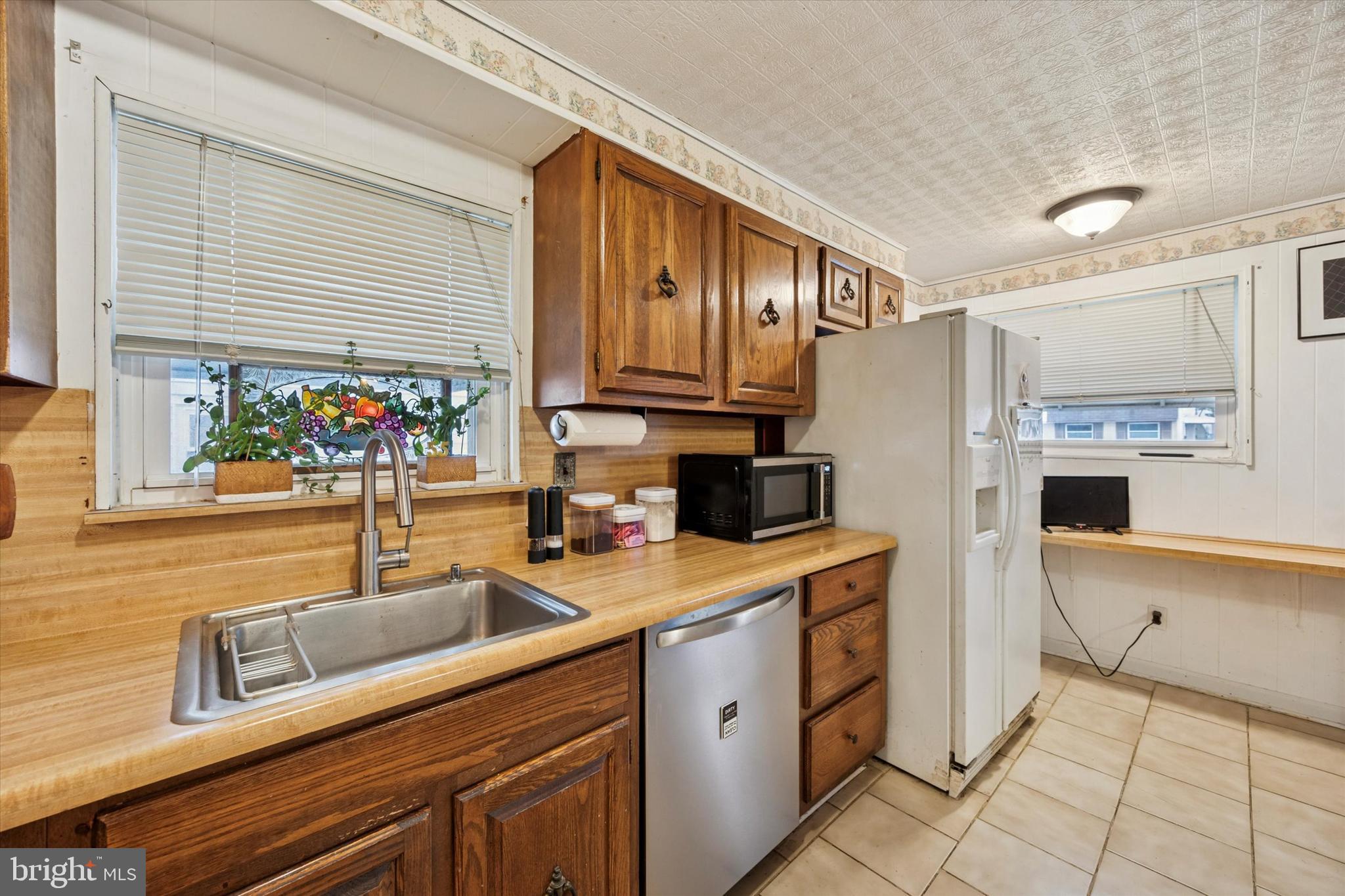 2831 Chase Road Philadelphia, PA 19152 - Photo 11 of 26 a kitchen with stainless steel appliances granite countertop a sink stove and refrigerator