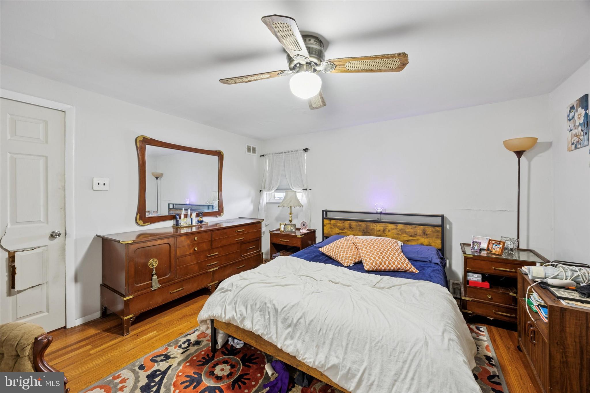 2831 Chase Road Philadelphia, PA 19152 - Photo 15 of 26 a bedroom with a bed and wooden floor