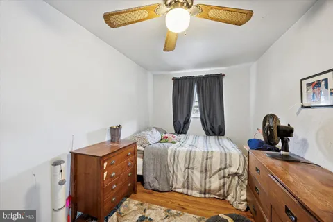 a bedroom with a bed and large mirror