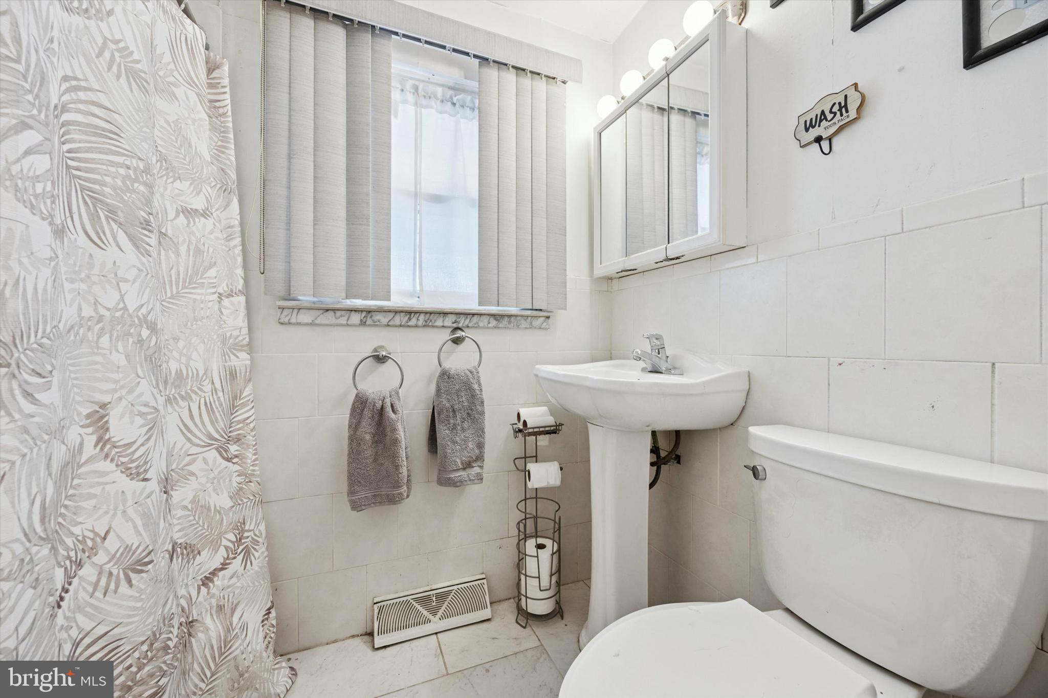 2831 Chase Road Philadelphia, PA 19152 - Photo 19 of 26 a bathroom with a sink toilet and shower
