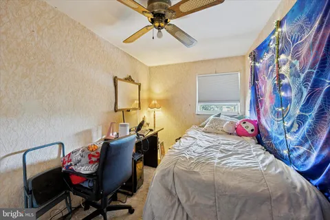 a bed room with a bed and a chair