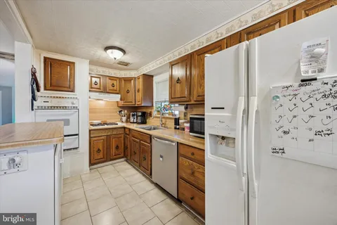 a kitchen with cabinets and appliances