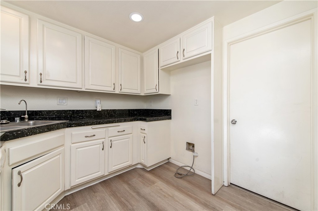 335 Stanford Court Irvine, CA 92612 - Photo 12 of 31 a kitchen with granite countertop white cabinets and white appliances