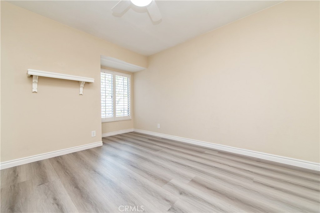 335 Stanford Court Irvine, CA 92612 - Photo 24 of 31 an empty room with wooden floor and windows