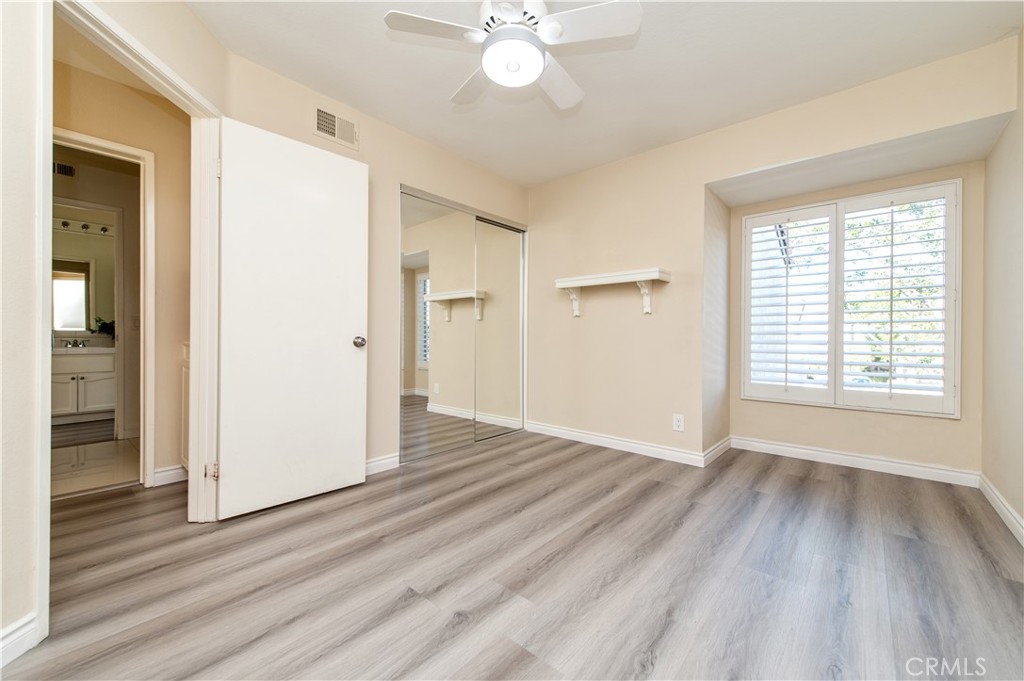 335 Stanford Court Irvine, CA 92612 - Photo 25 of 31 a view of an empty room with wooden floor and a window