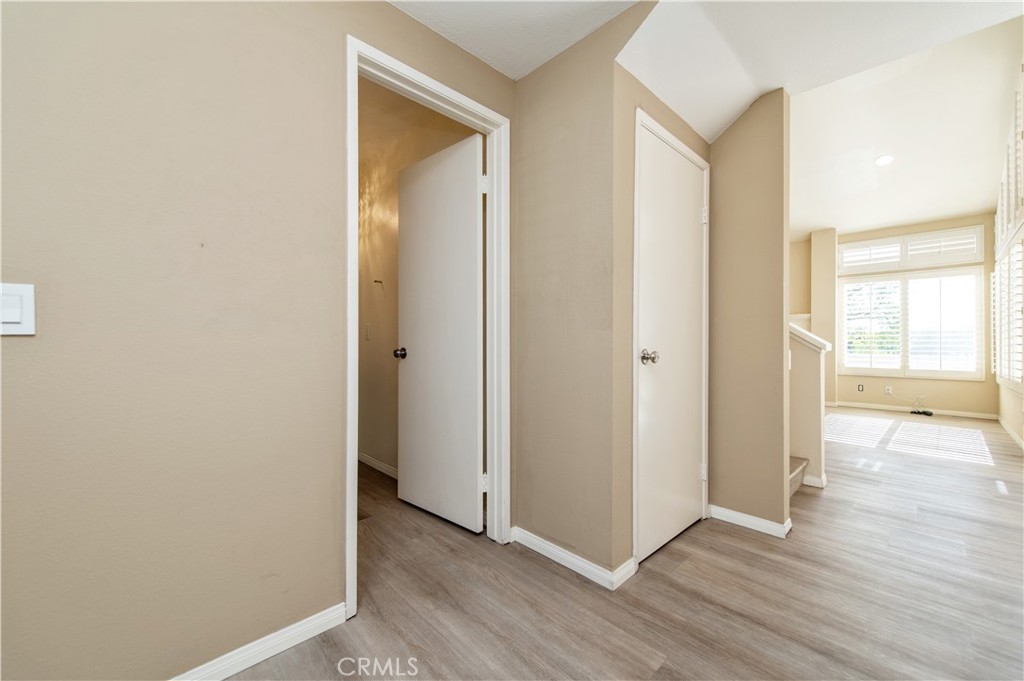 335 Stanford Court Irvine, CA 92612 - Photo 4 of 31 a view of a hallway with wooden floor