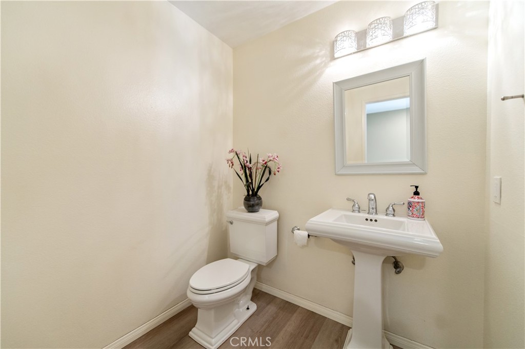 335 Stanford Court Irvine, CA 92612 - Photo 5 of 31 a bathroom with a toilet a sink and mirror