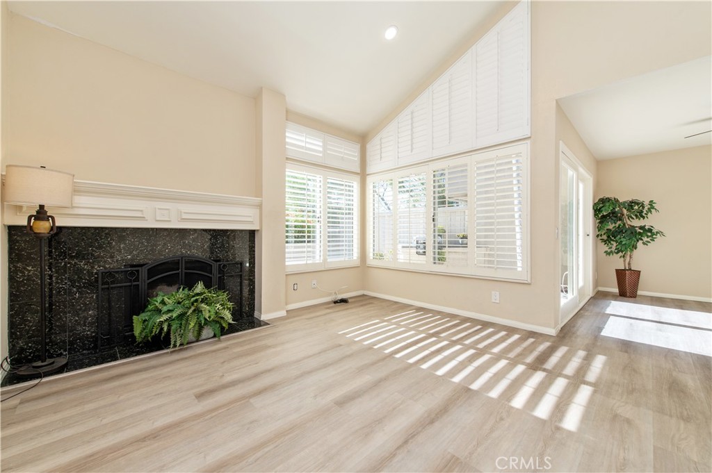 335 Stanford Court Irvine, CA 92612 - Photo 7 of 31 a view of an empty room with a fireplace and a window