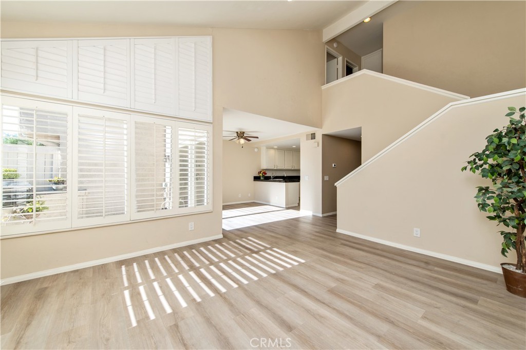 335 Stanford Court Irvine, CA 92612 - Photo 8 of 31 a view of an empty room with wooden floor and a window