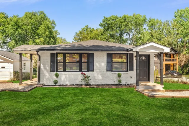a front view of a house with a yard and porch