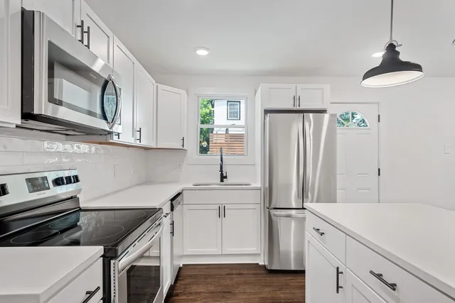 a kitchen with a sink stove and refrigerator