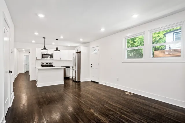 a view of kitchen with wooden floor and window
