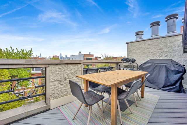 a terrace with outdoor seating and wooden floor