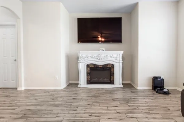 a living room with furniture a flat screen tv and a fireplace
