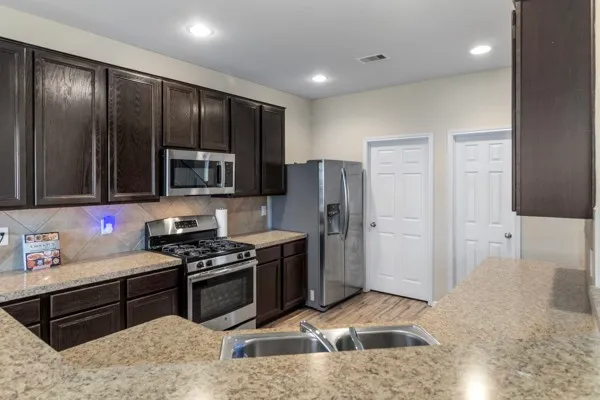 a bathroom with a sink a toilet and shower curtain