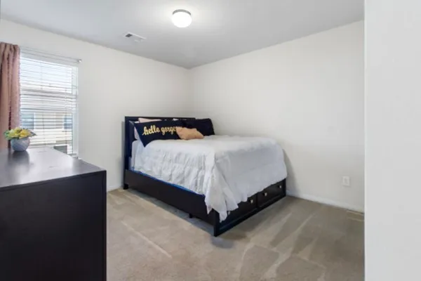 a bedroom with a bed and a window