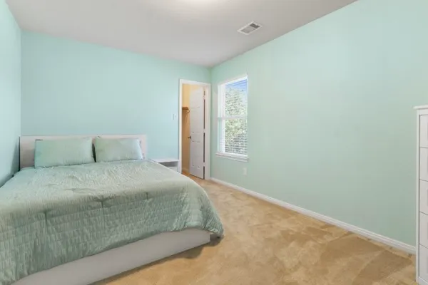 front view of a house with a yard and sitting area