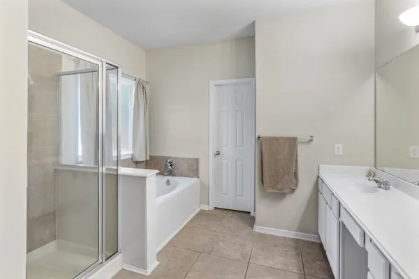 an aerial view of residential houses with outdoor space and parking