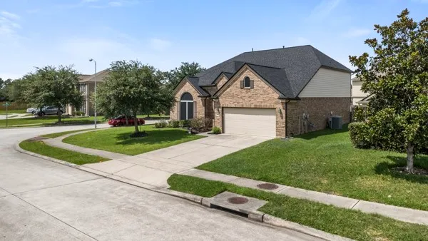 an aerial view of a house with a garden and a yard