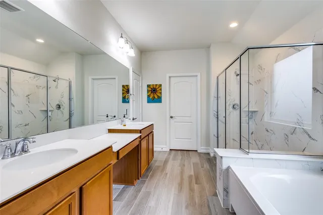 a spacious bathroom with a tub sink and mirror
