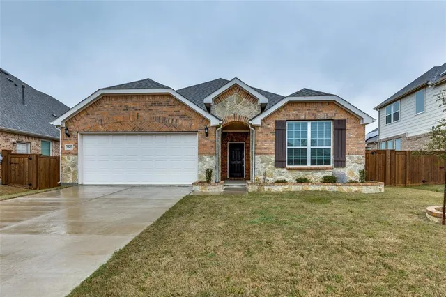 a view of a house with a yard and garage
