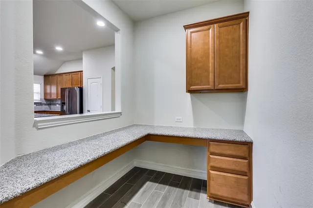 a kitchen with stainless steel appliances granite countertop a sink a stove and a wooden cabinets