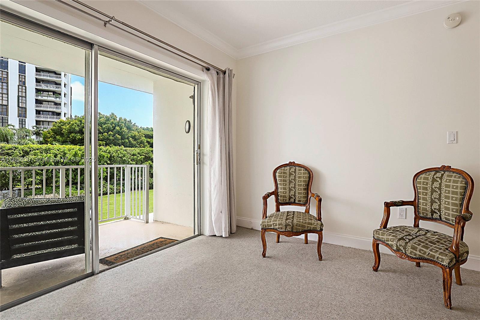 1700 Northeast 105th Street, Unit 203 Miami Shores, FL 33138 - Photo 21 of 45 a living room with furniture and a window