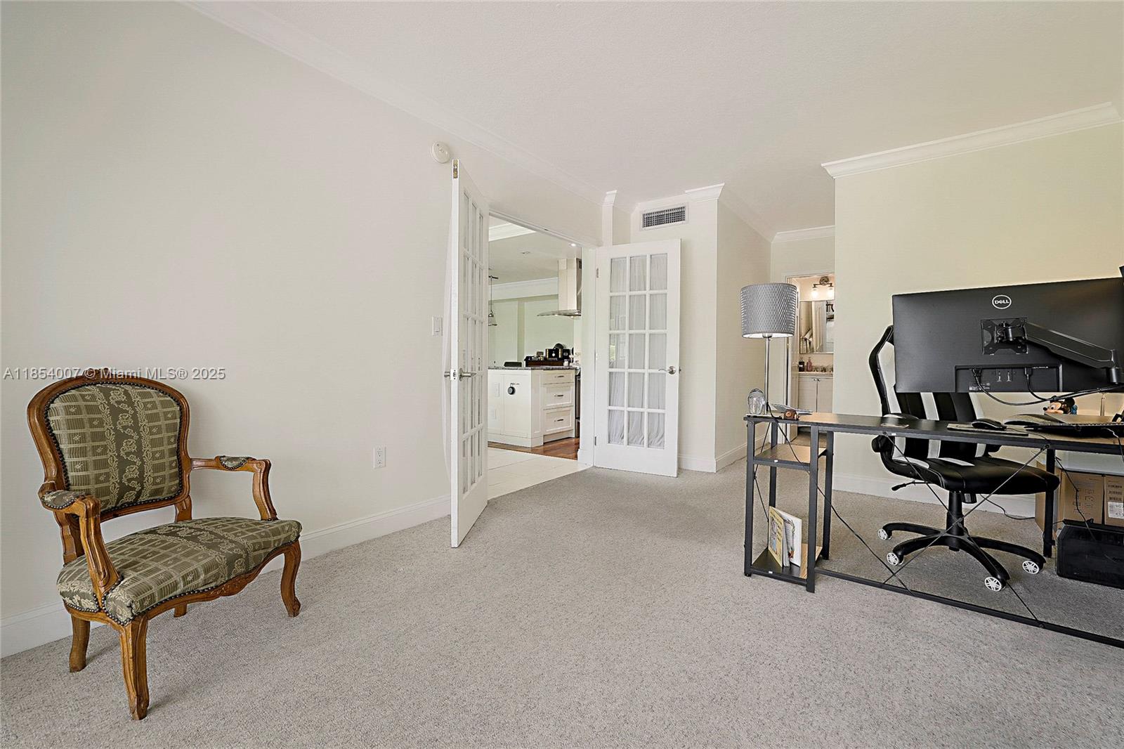 1700 Northeast 105th Street, Unit 203 Miami Shores, FL 33138 - Photo 23 of 45 a living room with furniture and a chair