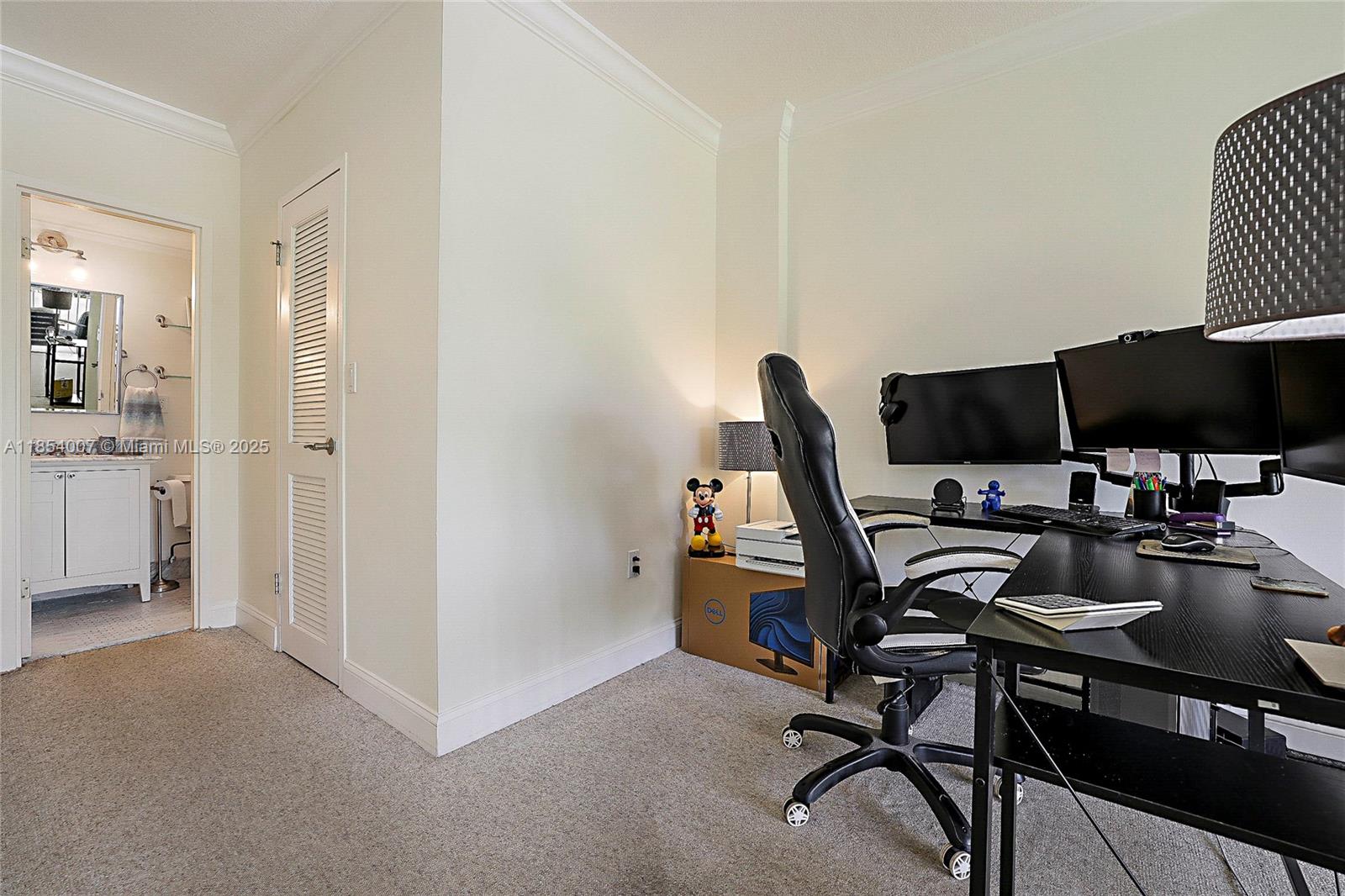 1700 Northeast 105th Street, Unit 203 Miami Shores, FL 33138 - Photo 24 of 45 a view of a workspace with furniture and a window