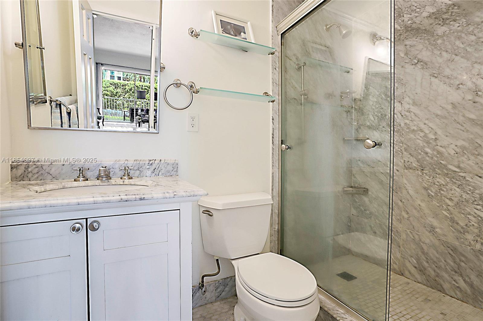 1700 Northeast 105th Street, Unit 203 Miami Shores, FL 33138 - Photo 25 of 45 a bathroom with a granite countertop sink a toilet and shower