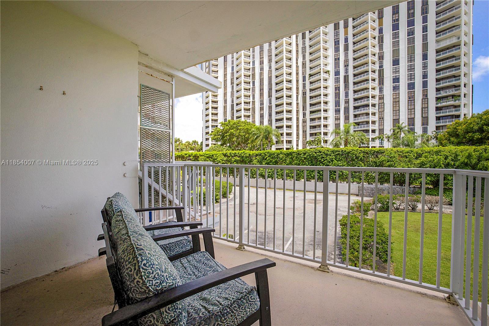 1700 Northeast 105th Street, Unit 203 Miami Shores, FL 33138 - Photo 26 of 45 a living room filled with furniture and a chair
